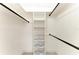 Organized walk-in closet with custom shelving and hanging rods, maximizing space for wardrobe storage at 1364 Westport Ln # 1403, Sarasota, FL 34232