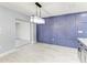 The dining room showcases an elegant crystal chandelier and a custom accent wall with millwork at 1364 Westport Ln # 1403, Sarasota, FL 34232