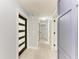 Inviting hallway featuring modern doors, neutral paint, and tile flooring that leads to various rooms at 1364 Westport Ln # 1403, Sarasota, FL 34232
