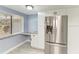 Modern kitchen featuring stainless steel refrigerator, white cabinets and granite countertop at 1364 Westport Ln # 1403, Sarasota, FL 34232