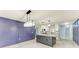 Open kitchen and dining area featuring an island with granite countertop and custom accent wall with millwork at 1364 Westport Ln # 1403, Sarasota, FL 34232