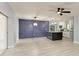 Open-concept kitchen featuring a granite island, modern lighting, and stainless steel appliances, seamlessly connecting to the living area at 1364 Westport Ln # 1403, Sarasota, FL 34232