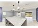 Modern kitchen with stainless steel appliances, large island with seating, and open layout to living area at 1364 Westport Ln # 1403, Sarasota, FL 34232