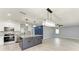 Open kitchen and dining area featuring a large island, modern lighting, and stainless steel appliances at 1364 Westport Ln # 1403, Sarasota, FL 34232