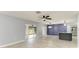 Open-concept living room featuring a granite island, modern lighting, and stainless steel appliances, with sliding glass door to outdoors at 1364 Westport Ln # 1403, Sarasota, FL 34232
