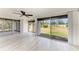 Bright living room with large sliding glass doors and stylish ceiling fan, flooding the space with natural light at 1364 Westport Ln # 1403, Sarasota, FL 34232