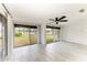 Inviting living area featuring large sliding glass doors offering views of the outdoors, complemented by a ceiling fan at 1364 Westport Ln # 1403, Sarasota, FL 34232