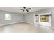 Spacious main bedroom with natural light, featuring a ceiling fan and sliding glass doors to the outside at 1364 Westport Ln # 1403, Sarasota, FL 34232
