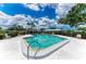 Community pool with covered seating area for residents at 1364 Westport Ln # 1403, Sarasota, FL 34232