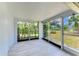 Relaxing sunroom with tile floors and screened windows overlooking lush backyard at 1364 Westport Ln # 1403, Sarasota, FL 34232