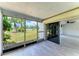 Bright sunroom with tile floors and sliding door leading to a large, grassy backyard at 1364 Westport Ln # 1403, Sarasota, FL 34232