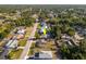 Wide aerial view of a home in a neighborhood with mature trees and well-maintained lawns at 1434 Beacon Dr, Port Charlotte, FL 33952