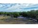 Aerial view of the property showcasing the home, large yard, and surrounding trees at 15308 Fruitville Rd, Sarasota, FL 34240
