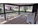 This back porch features a washer and dryer and is screened in with a view of the barn at 15308 Fruitville Rd, Sarasota, FL 34240