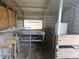 This barn interior features chicken wire walls, plywood walls, dirt floors, and wood divider walls at 15308 Fruitville Rd, Sarasota, FL 34240