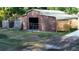A barn with a lean-to and a gated entrance is in the backyard of this home at 15308 Fruitville Rd, Sarasota, FL 34240