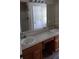 Bathroom featuring double sink vanity, expansive mirror, and good lighting at 15308 Fruitville Rd, Sarasota, FL 34240