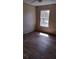 Bright bedroom with a window and new wood laminate flooring at 15308 Fruitville Rd, Sarasota, FL 34240