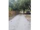Long gravel driveway lined by a wooden fence and mature trees at 15308 Fruitville Rd, Sarasota, FL 34240