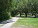 Gravel driveway lined with trees at 15308 Fruitville Rd, Sarasota, FL 34240
