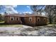 Charming ranch-style home with tan siding, light shutters, and a well-maintained front yard at 15308 Fruitville Rd, Sarasota, FL 34240