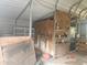 Garage interior featuring plywood walls, metal shelving, and organized storage for tools and supplies at 15308 Fruitville Rd, Sarasota, FL 34240