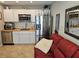 Compact kitchen featuring stainless steel appliances, white cabinets, and a wood-look countertop at 15308 Fruitville Rd, Sarasota, FL 34240