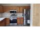 Well-equipped kitchen featuring stainless steel appliances, light wood cabinets, and white countertops at 15308 Fruitville Rd, Sarasota, FL 34240