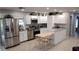 Bright kitchen with stainless steel appliances, white cabinetry, marble counters, and adjacent dining space at 15308 Fruitville Rd, Sarasota, FL 34240