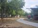 Houses, barn, sheds, and red tractor in a rural landscape at 15308 Fruitville Rd, Sarasota, FL 34240