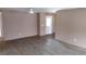 View of an open-concept living room showcasing the laminate floor and exterior door at 15308 Fruitville Rd, Sarasota, FL 34240