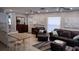 A spacious living room with leather furniture, tile floors, a ceiling fan, and neutral colored walls at 15308 Fruitville Rd, Sarasota, FL 34240