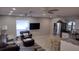 Open-concept living room featuring modern ceiling fans, large windows, and tile flooring at 15308 Fruitville Rd, Sarasota, FL 34240