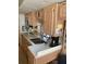 RV kitchenette featuring sink, microwave, and ample cabinet space at 15308 Fruitville Rd, Sarasota, FL 34240