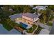 Aerial view showcasing a modern home with a large pool, lush landscaping, and expansive outdoor living areas at 1559 Bay Rd, Sarasota, FL 34239
