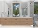 Modern bathroom featuring double vanity, quartz countertop, large mirrors and walk-in shower with glass partition at 1559 Bay Rd, Sarasota, FL 34239