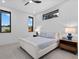 Cozy bedroom with soft carpet, minimalist decor, and ample natural light from three large windows at 1559 Bay Rd, Sarasota, FL 34239