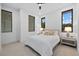 Bright and airy bedroom with neutral tones, soft carpet and abundant natural light from three large windows at 1559 Bay Rd, Sarasota, FL 34239