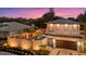 Charming exterior featuring a well-lit facade, private fence, and lush landscaping around the property at 1559 Bay Rd, Sarasota, FL 34239