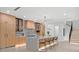 Modern kitchen with stainless steel appliances, custom cabinets, large island with seating and stylish pendant lights at 1559 Bay Rd, Sarasota, FL 34239