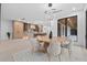 Open-concept kitchen and dining area with modern lighting, light wood cabinetry, and backyard view at 1559 Bay Rd, Sarasota, FL 34239