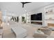 Open-concept space with modern fireplace, staircase, and dining area beyond at 1559 Bay Rd, Sarasota, FL 34239