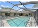 Inviting screened-in pool with plenty of seating offers the perfect spot for relaxation at 1661 Cottonwood Trl, Sarasota, FL 34232