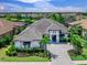 Overhead angle of a beautiful house with a large roof, paver driveway, and lush landscaping at 16614 Berwick Ter, Lakewood Ranch, FL 34202