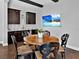 A modern dining area with dark cabinetry, and a TV mounted on the wall at 16614 Berwick Ter, Lakewood Ranch, FL 34202