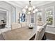 Bright dining room featuring a modern chandelier, wainscotting, and plantation shutters at 16614 Berwick Ter, Lakewood Ranch, FL 34202