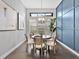 Cozy dining area with natural light, designer light fixture, and stylish blue accent wall at 16614 Berwick Ter, Lakewood Ranch, FL 34202