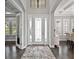 Elegant foyer with decorative front door and glass sidelights, a patterned rug, and neutral walls at 16614 Berwick Ter, Lakewood Ranch, FL 34202