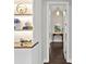Bright hallway with decor and doorway to a room with an ocean-themed painting at 16614 Berwick Ter, Lakewood Ranch, FL 34202