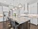 Modern kitchen with granite counters, stainless steel appliances, a central island with bar seating and pendant lights at 16614 Berwick Ter, Lakewood Ranch, FL 34202